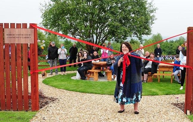 a woman cutting a ribbon