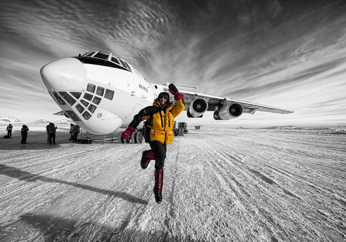 Climber celebrates after landing on Union Glacier