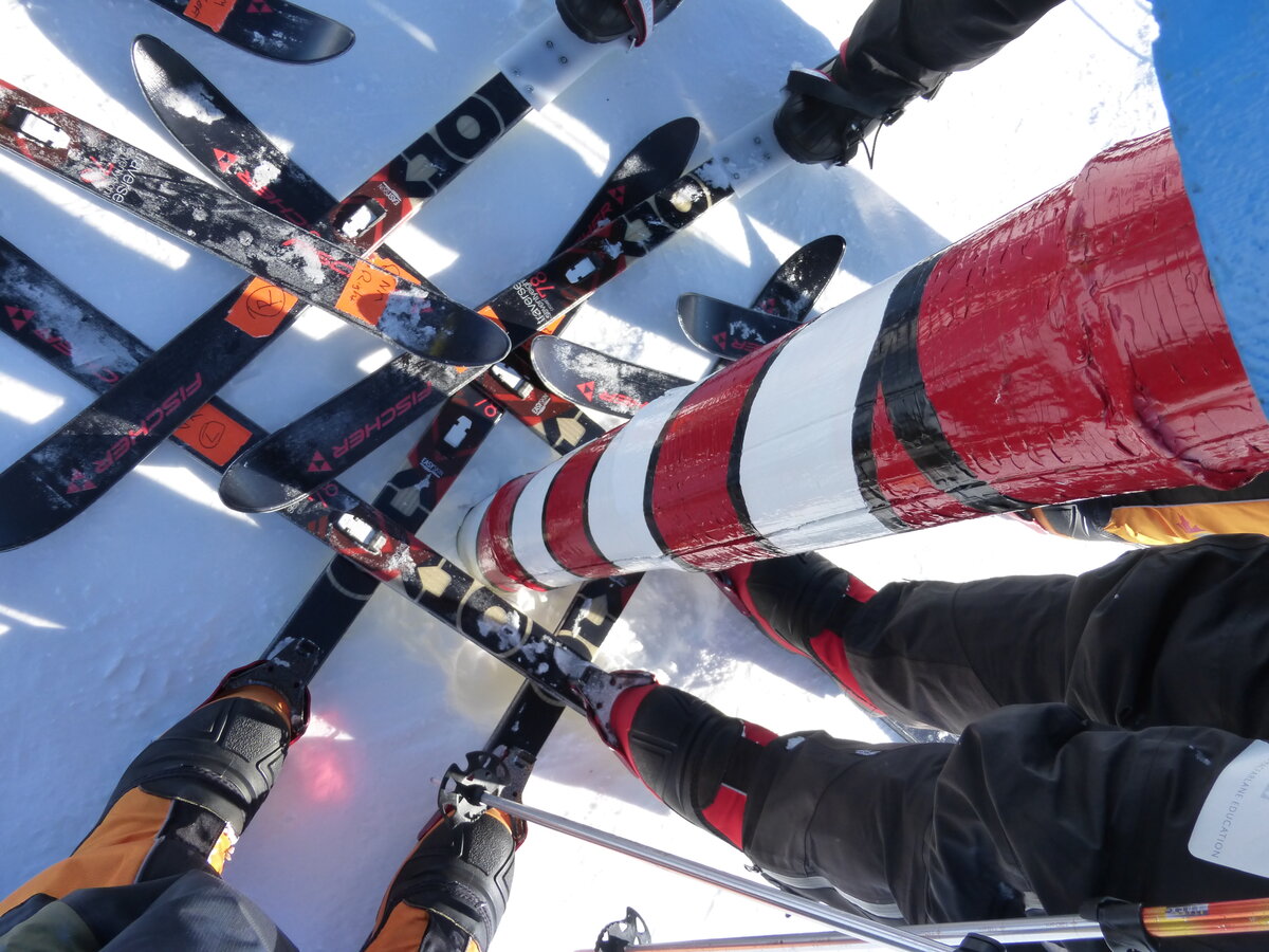 Ski team skis, criss-crossed around the Ceremonial South Pole